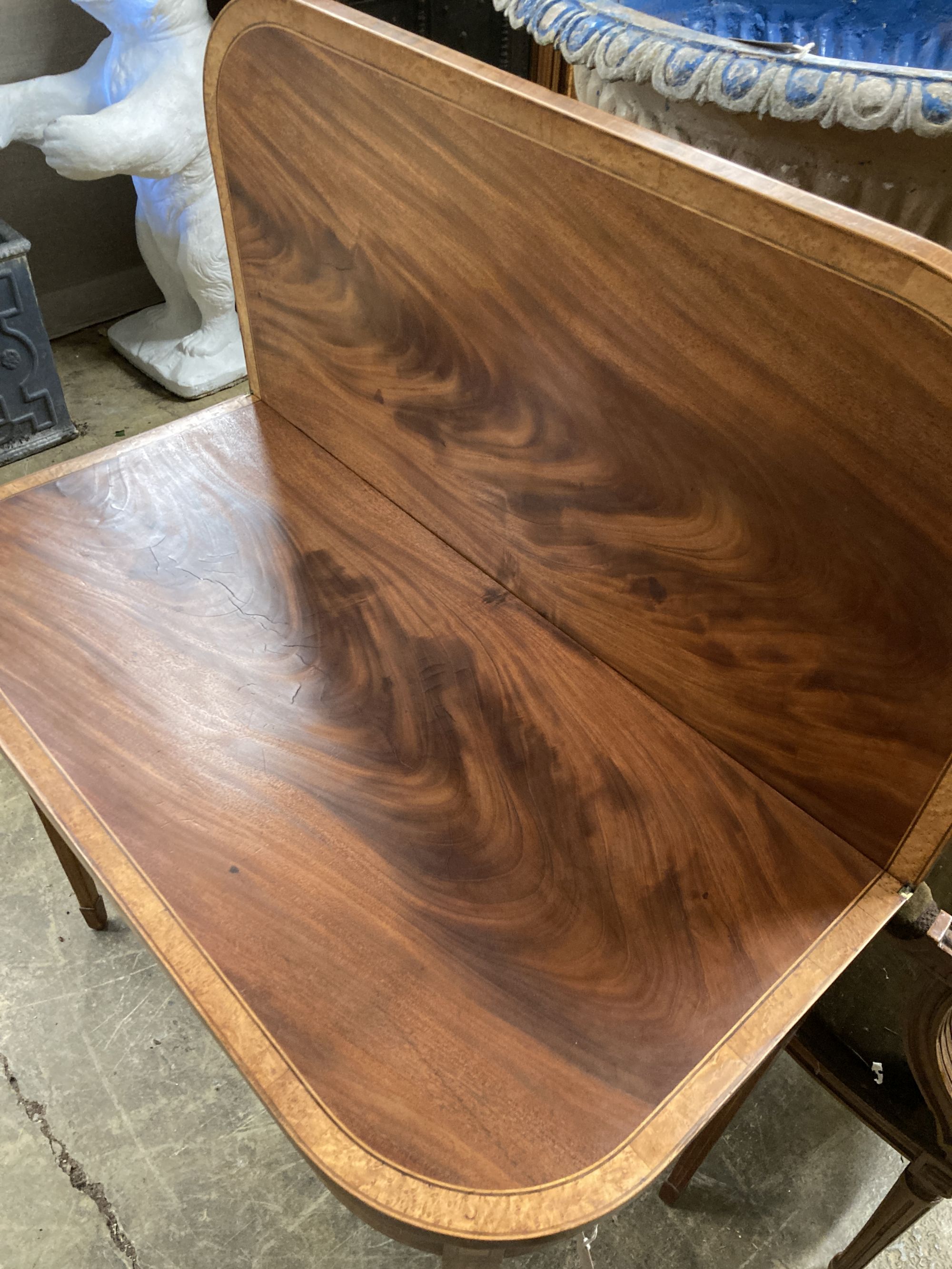 A George III bird's eye maple banded mahogany folding tea table, width 91cm, depth 46cm, height 75cm
